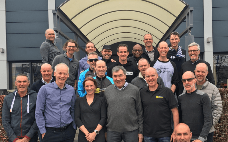 Group photo of Mummu Cycling guests with Eddie Merckx