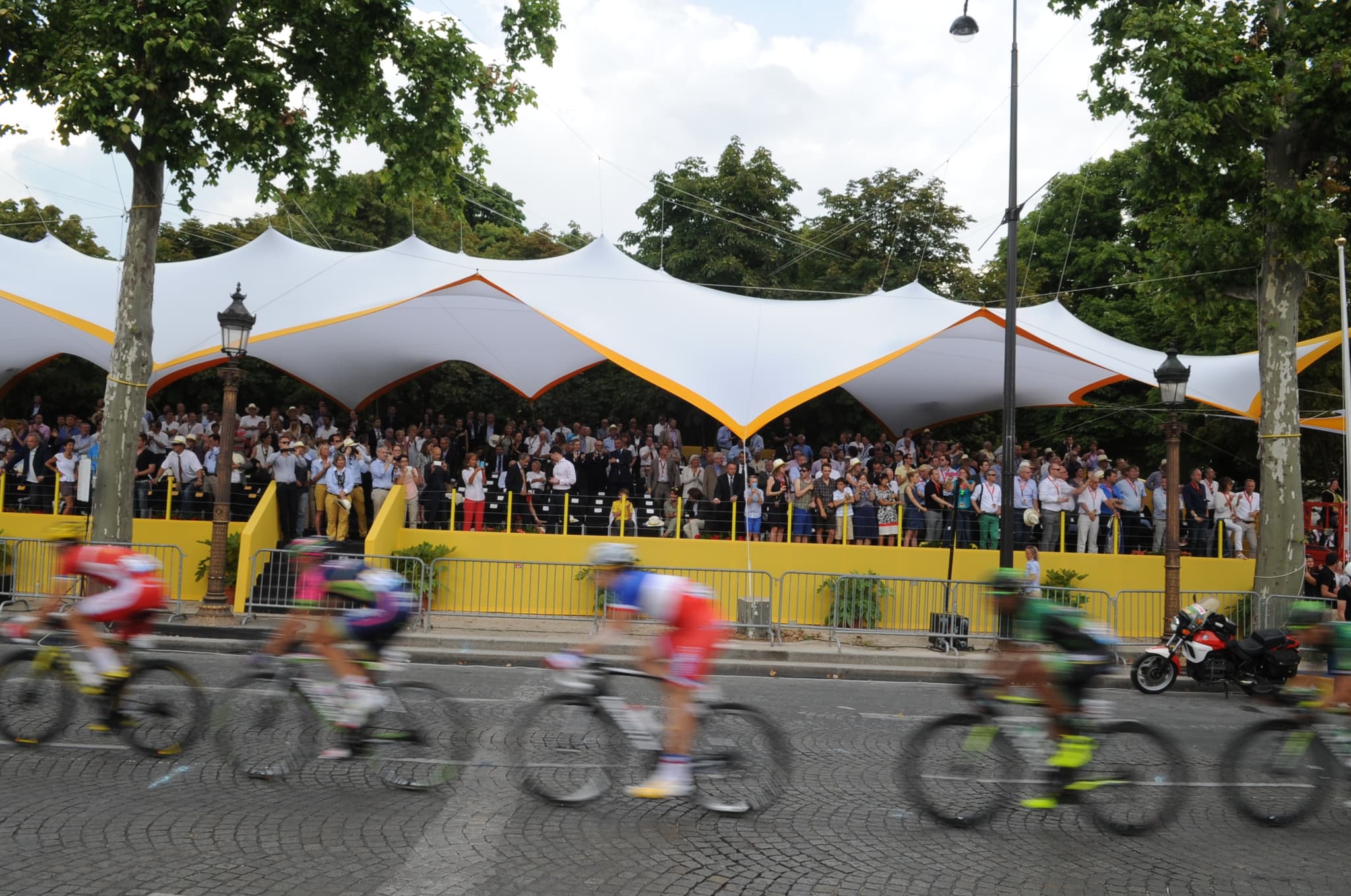 Peloton racing past grandstand, Tour de France