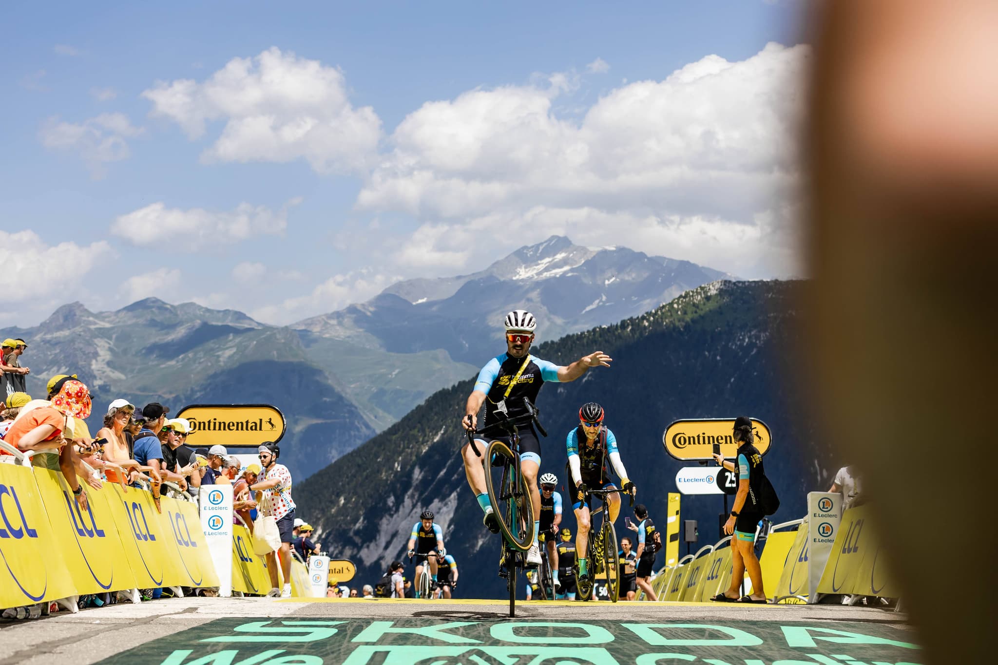 Cyclists on mountain road, Tour de France backdrop