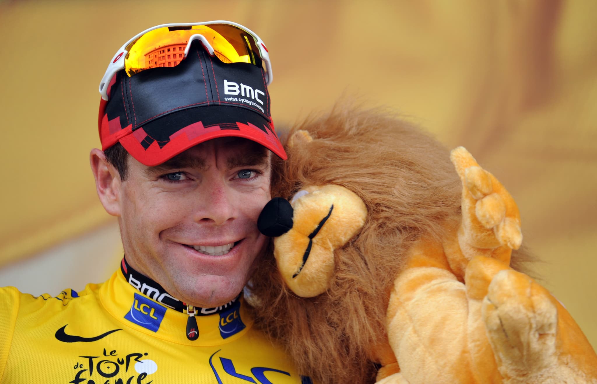 Cadel Evans in yellow jersey with lion plush toy