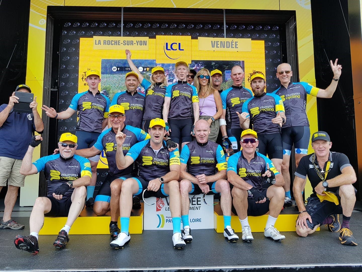 Mummu Cycling group photo on podium in La Roche-sur-Yon, Vendée